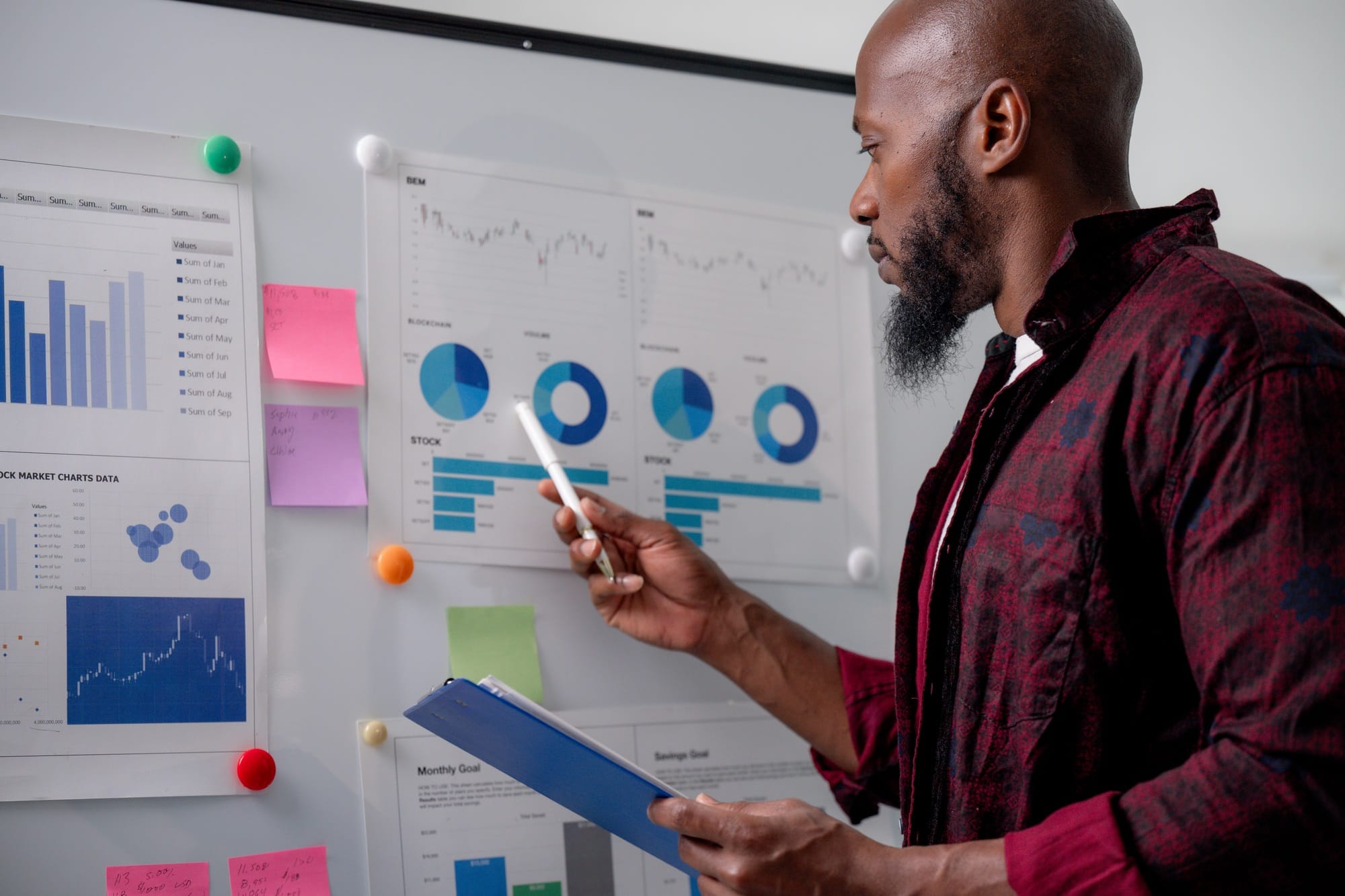 Businessman analyzing financial data, using charts and reports to make strategic decisions for company growth
