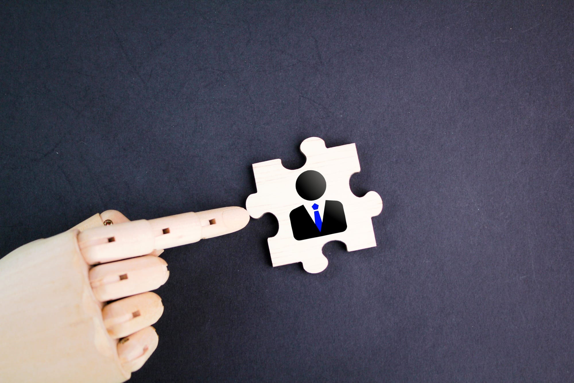 Wooden puzzle with leader icon. Wooden puzzle with employee image.